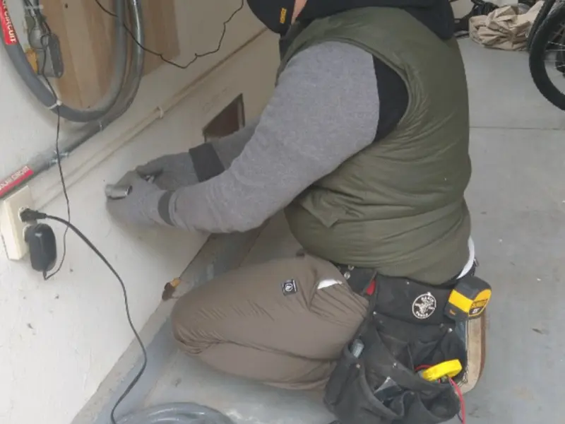 Electrician performing outlet wiring in a La Palma garage