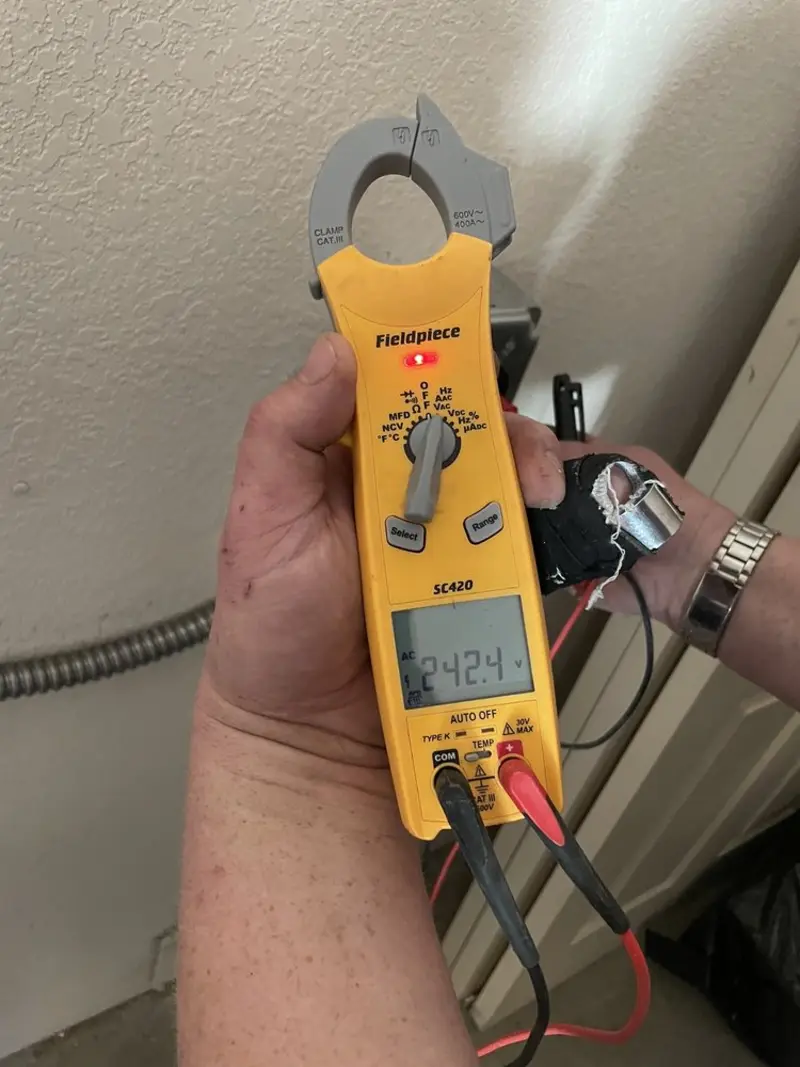 Voltage testing with clamp meter during Ceiling Fan Installation in La Palma